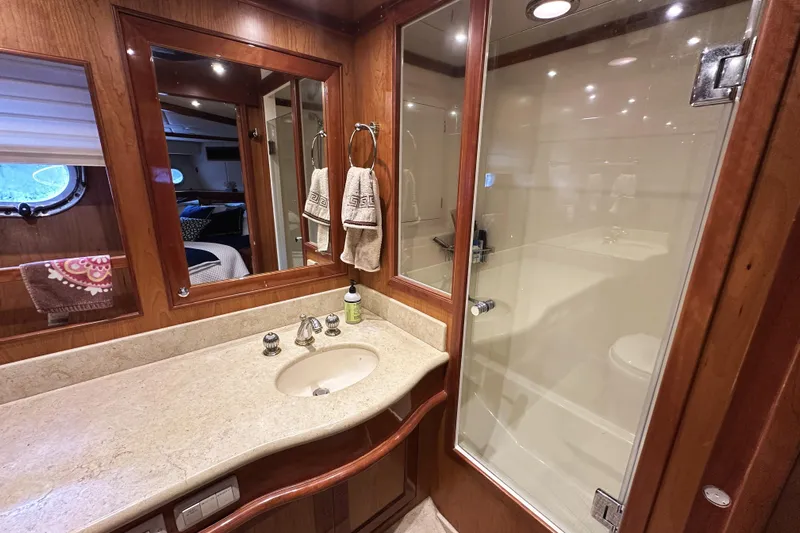 Times Like These Yacht Photos Pics Luxurious bathroom in 2004 McKinna 57 PHMY yacht with wood accents and glass shower.