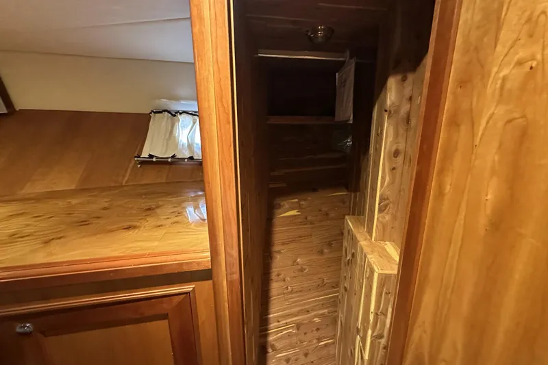 Times Like These Yacht Photos Pics Wooden interior of 2004 McKinna 57 PHMY Widebody yacht, featuring polished surfaces and cozy design.