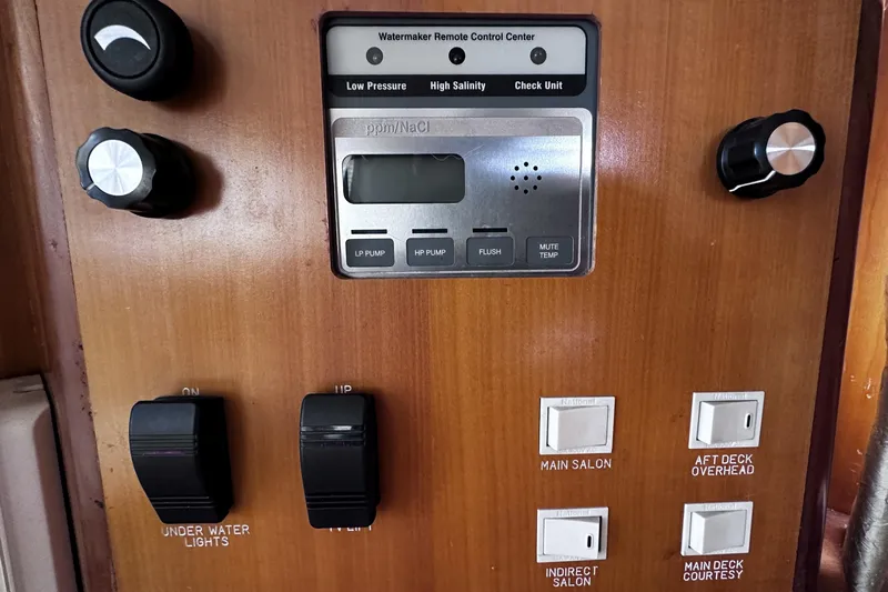 Times Like These Yacht Photos Pics Control panel of a 2004 McKinna 57 PHMY Widebody yacht with various switches and dials.