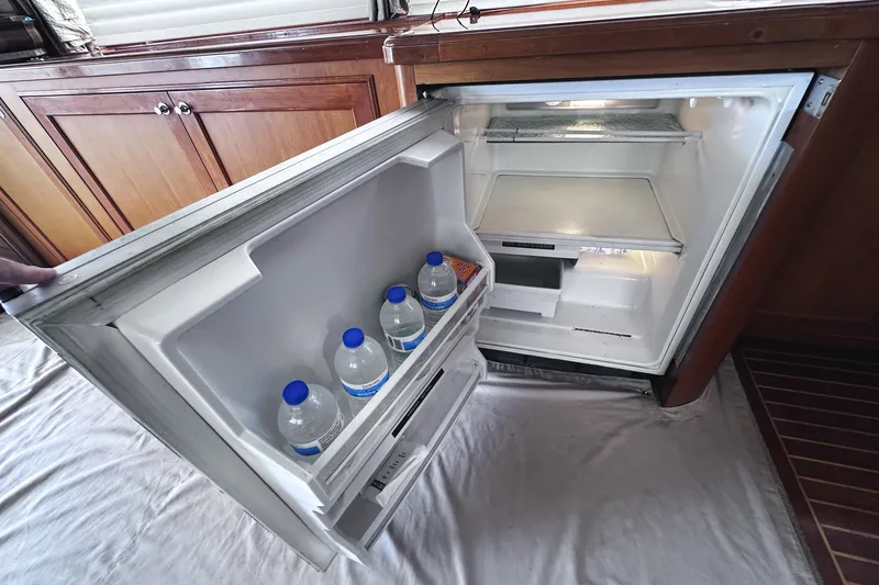 Times Like These Yacht Photos Pics Open fridge on 2004 McKinna 57 PHMY yacht, containing water bottles and a snack.