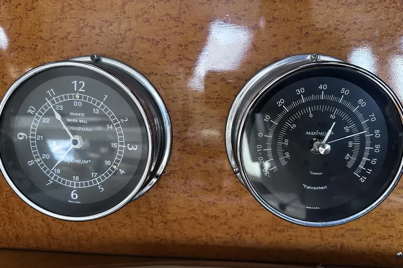 Times Like These Yacht Photos Pics Analog clock and thermometer on McKinna 57 PHMY Widebody yacht dashboard, 2004 model.