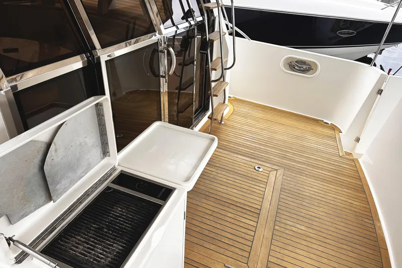 Times Like These Yacht Photos Pics 2004 McKinna 57 PHMY yacht deck with wood flooring and outdoor grill.