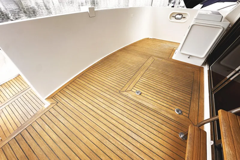 Times Like These Yacht Photos Pics Teak deck of 2004 McKinna 57 PHMY Widebody yacht, showcasing elegant wood finish.