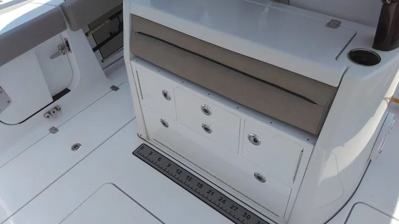  Yacht Photos Pics 2022 Sportsman Open 302 Center Console boat interior with storage drawers and measuring ruler.