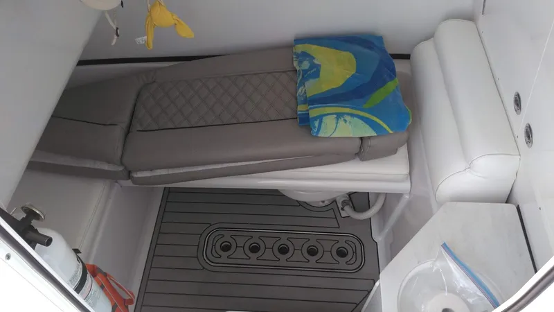  Yacht Photos Pics 2022 Sportsman Open 302 Center Console cabin interior with seating and storage.