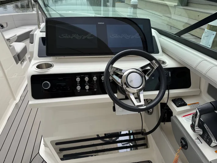  Yacht Photos Pics 2024 Sea Ray SLX 310 Outboard cockpit with modern steering and instruments.