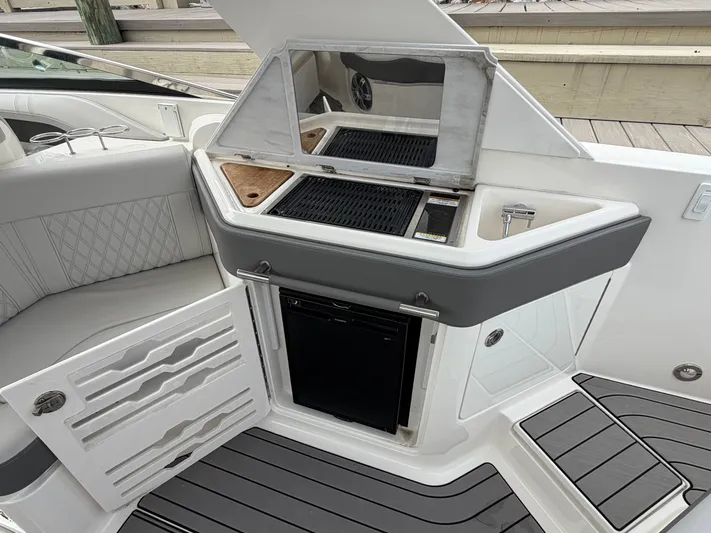  Yacht Photos Pics 2024 Sea Ray SLX 310 Outboard boat kitchen with grill and fridge.