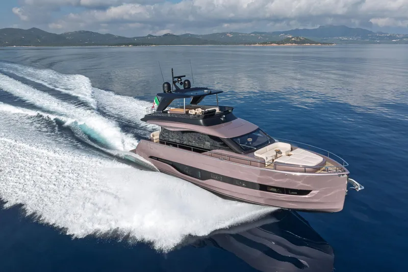  Yacht Photos Pics 2026 Cranchi Sessantadue 62 yacht cruising on open water, showcasing sleek design and luxury.