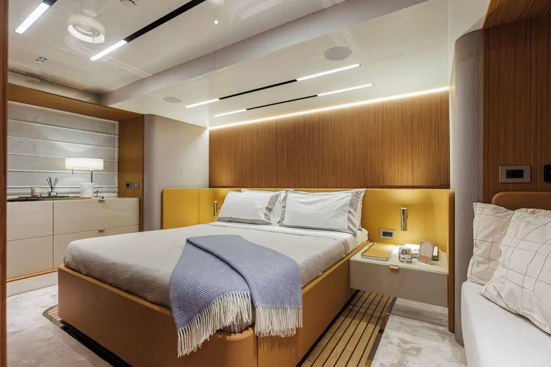  Yacht Photos Pics Luxurious bedroom interior of 2026 Cranchi Sessantadue 62 yacht with modern design elements.