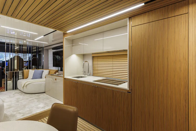  Yacht Photos Pics Luxurious interior of 2026 Cranchi Sessantadue 62 yacht with modern kitchen and seating area.