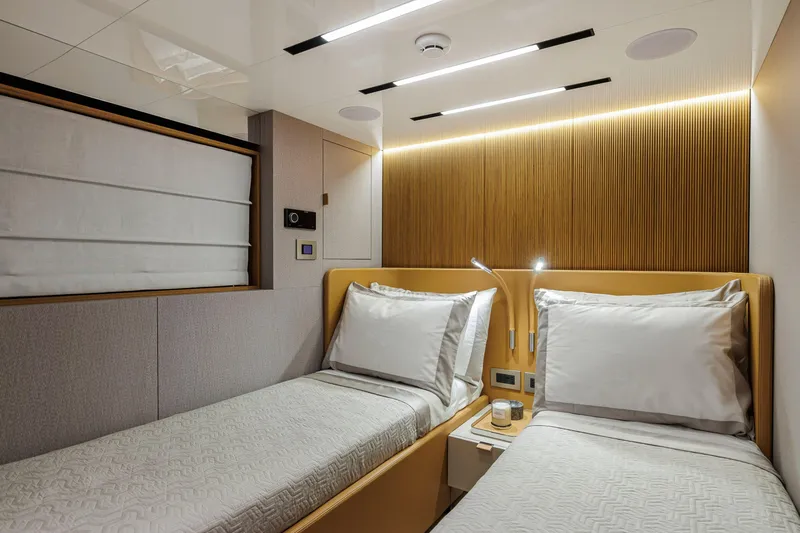  Yacht Photos Pics Luxurious twin cabin interior of 2026 Cranchi Sessantadue 62 yacht, featuring modern design and ambient lighting.