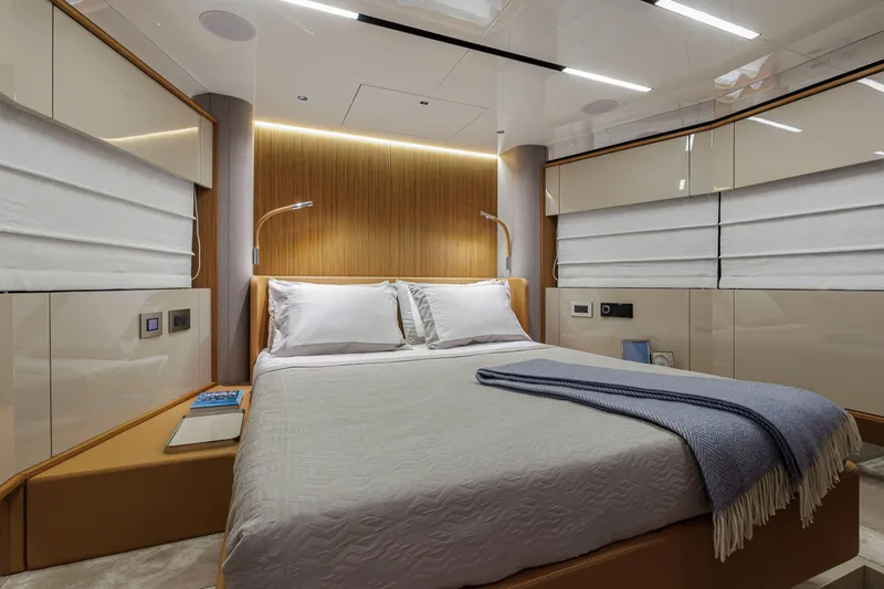  Yacht Photos Pics Luxurious bedroom interior of 2026 Cranchi Sessantadue 62 yacht with modern design.
