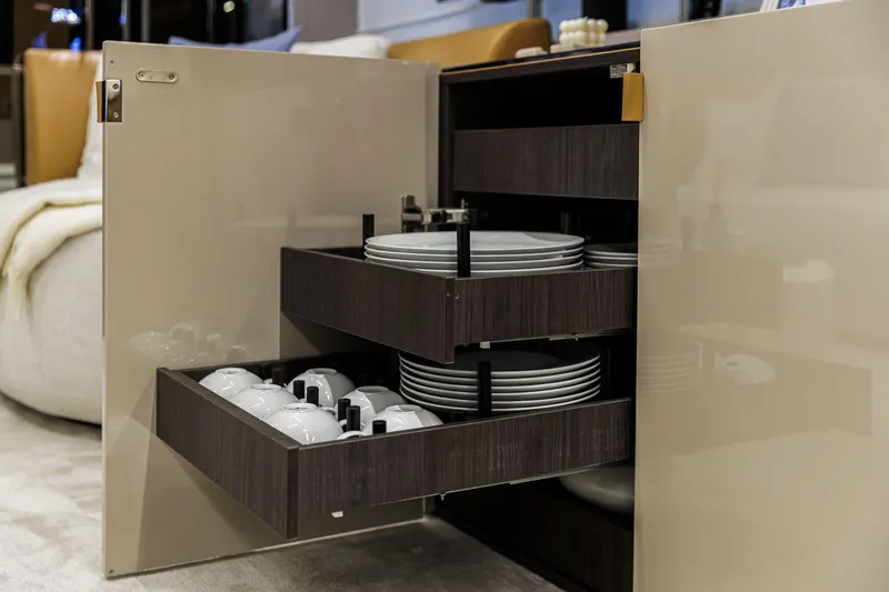  Yacht Photos Pics Luxury yacht Cranchi Sessantadue 62 interior with open cabinet displaying plates and cups.