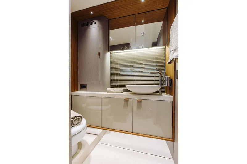  Yacht Photos Pics Luxurious bathroom interior of 2026 Cranchi Sessantadue 62 yacht with modern sink and cabinetry.