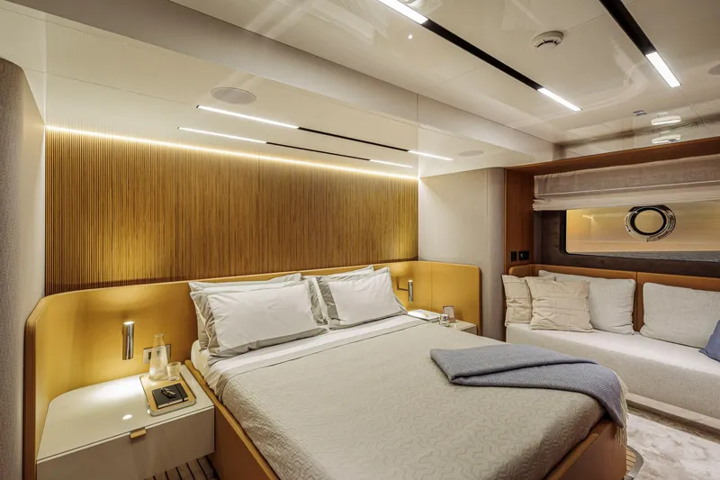  Yacht Photos Pics Luxurious bedroom interior of 2026 Cranchi Sessantadue 62 yacht with modern design and cozy ambiance.