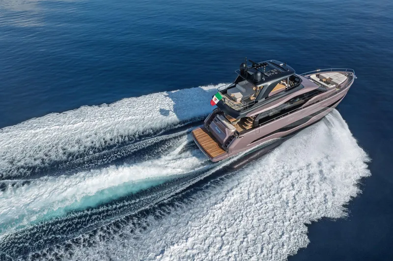  Yacht Photos Pics 2026 Cranchi Sessantadue 62 yacht cruising on open sea, aerial view.