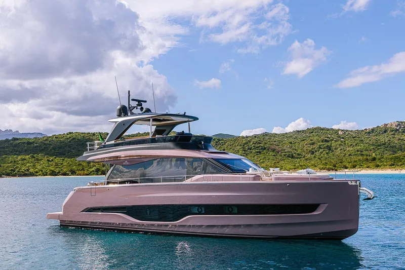  Yacht Photos Pics 2026 Cranchi Sessantadue 62 yacht on serene water with lush green hills.