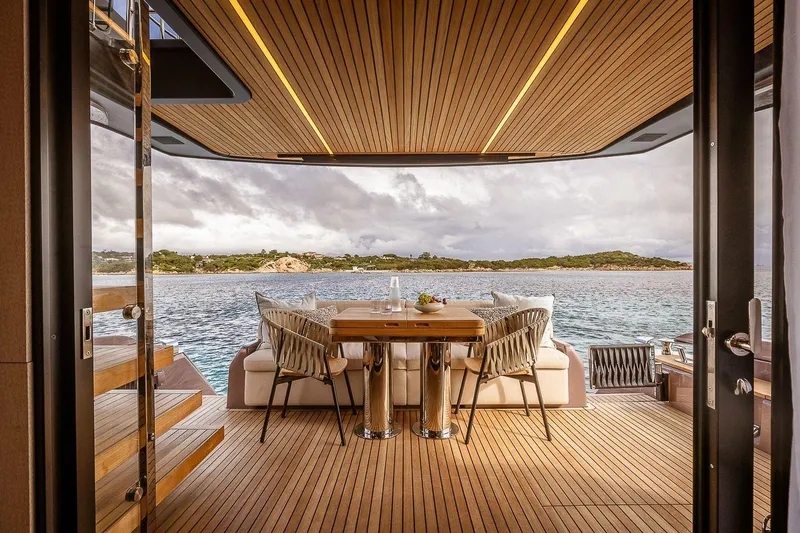  Yacht Photos Pics Luxurious 2026 Cranchi Sessantadue 62 yacht interior with elegant dining area and scenic ocean view.
