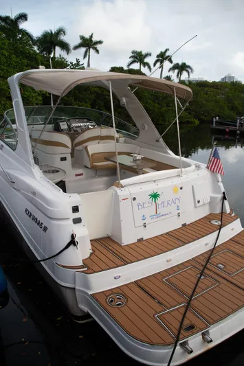  Yacht Photos Pics 2005 Four Winns 378 Vista boat docked with American flag, tropical backdrop.