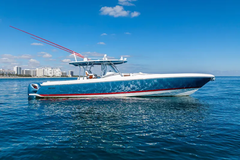  Yacht Photos Pics 2015 Intrepid 475 Panacea boat on calm ocean with city skyline in background.
