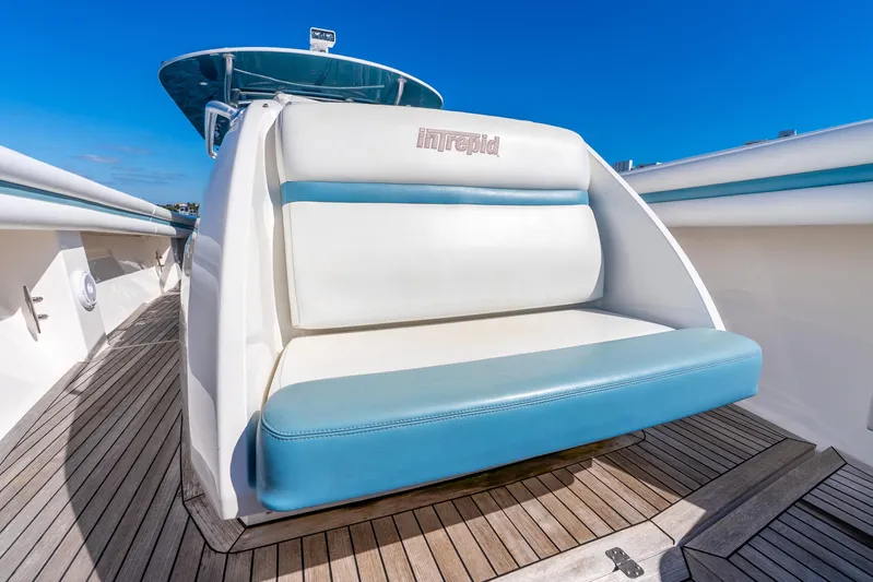  Yacht Photos Pics 2015 Intrepid 475 Panacea boat seat with blue and white upholstery on teak deck.