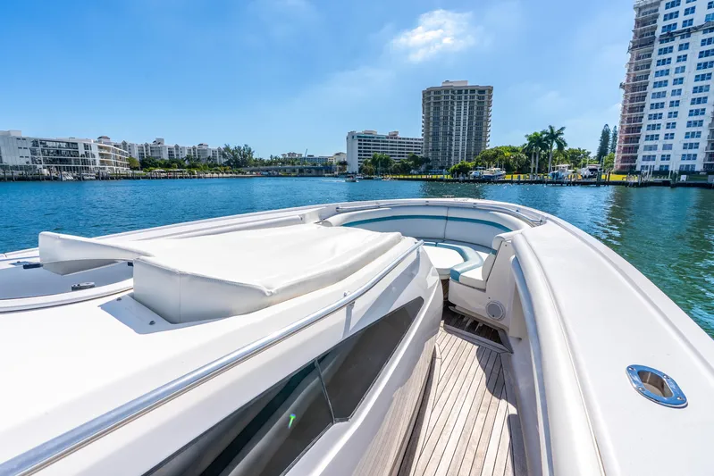  Yacht Photos Pics 2015 Intrepid 475 Panacea yacht on calm water, cityscape in background.