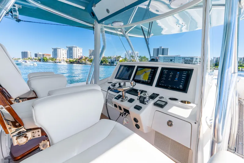  Yacht Photos Pics 2015 Intrepid 475 Panacea helm with modern controls and waterfront city view.