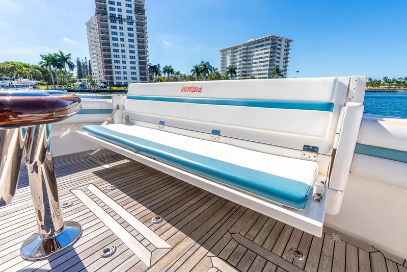  Yacht Photos Pics 2015 Intrepid 475 Panacea boat interior with cushioned seating and wooden deck.
