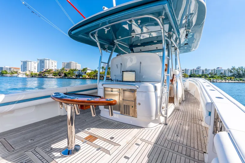  Yacht Photos Pics 2015 Intrepid 475 Panacea yacht with sleek deck and modern amenities, docked by waterfront buildings.