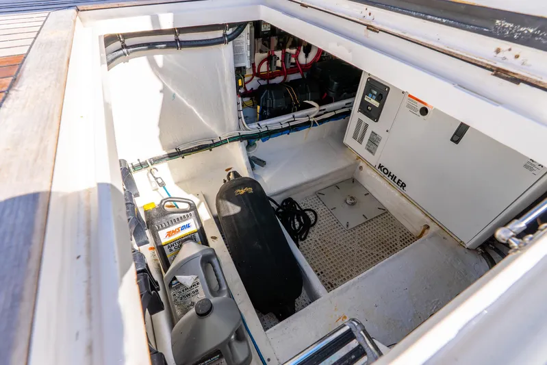  Yacht Photos Pics Engine compartment of 2015 Intrepid 475 Panacea with Kohler generator and maintenance supplies.
