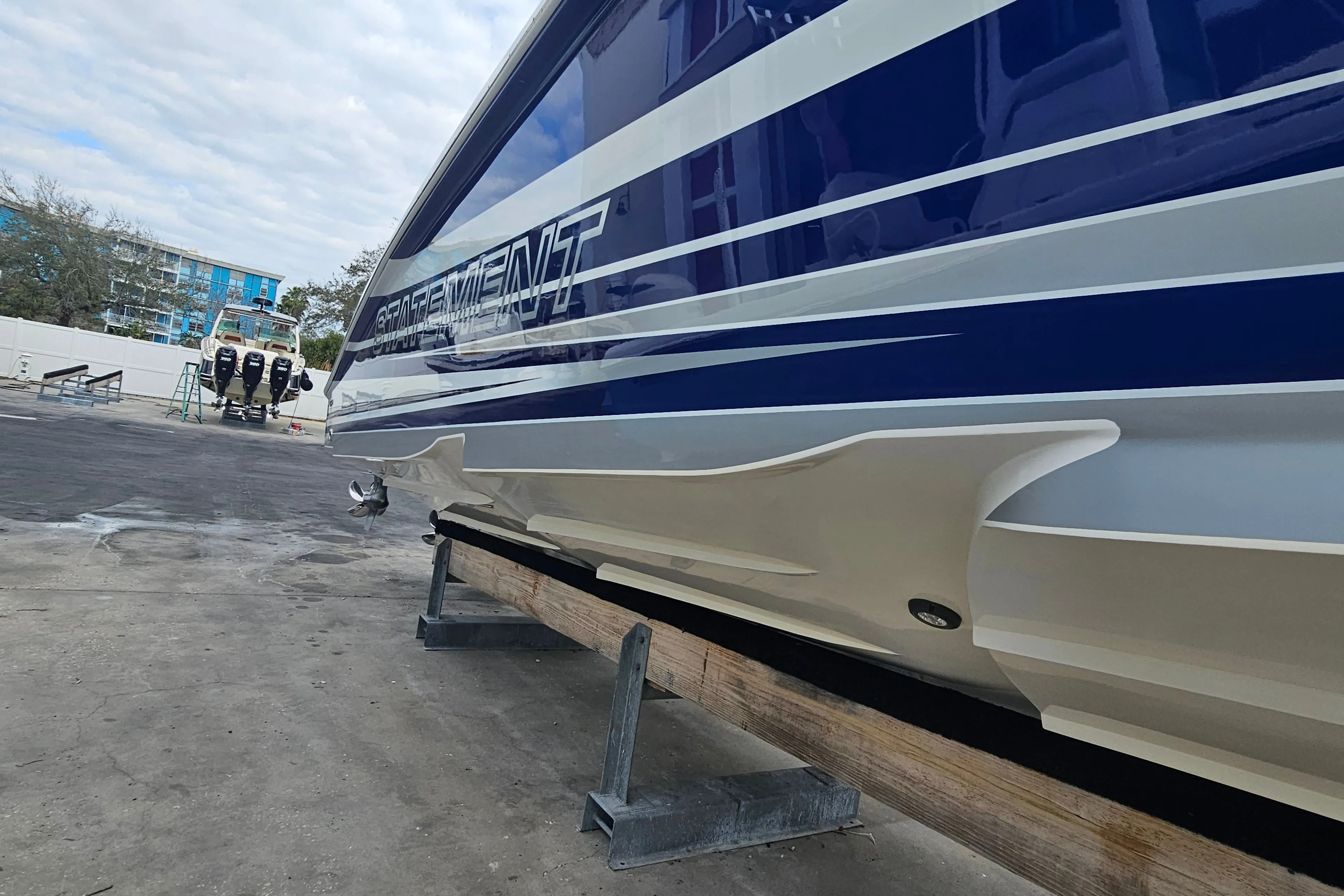 Statement 380 Open 2022 boat on a trailer, side view.