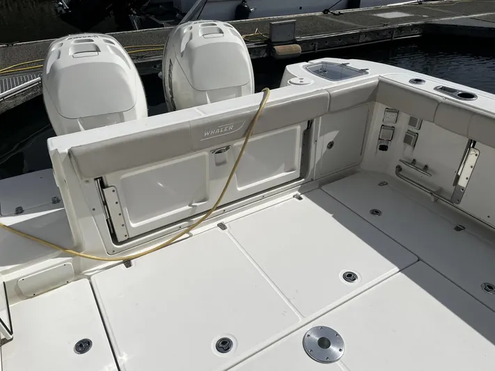  Yacht Photos Pics 2017 Boston Whaler 315 Conquest boat deck with dual engines, docked at marina.