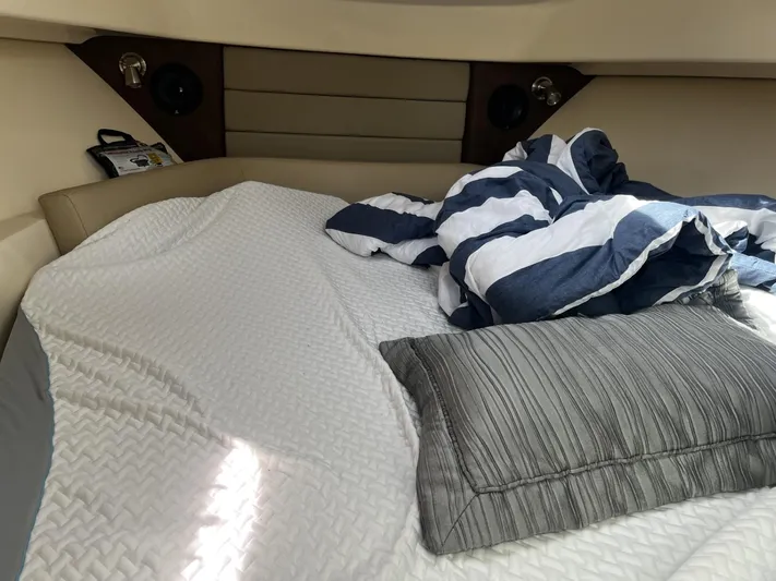  Yacht Photos Pics Cozy cabin interior of 2017 Boston Whaler 315 Conquest with bedding and pillows.