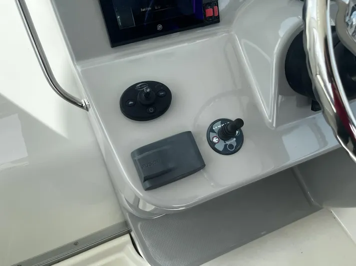  Yacht Photos Pics Control panel of 2017 Boston Whaler 315 Conquest boat, featuring steering and navigation controls.