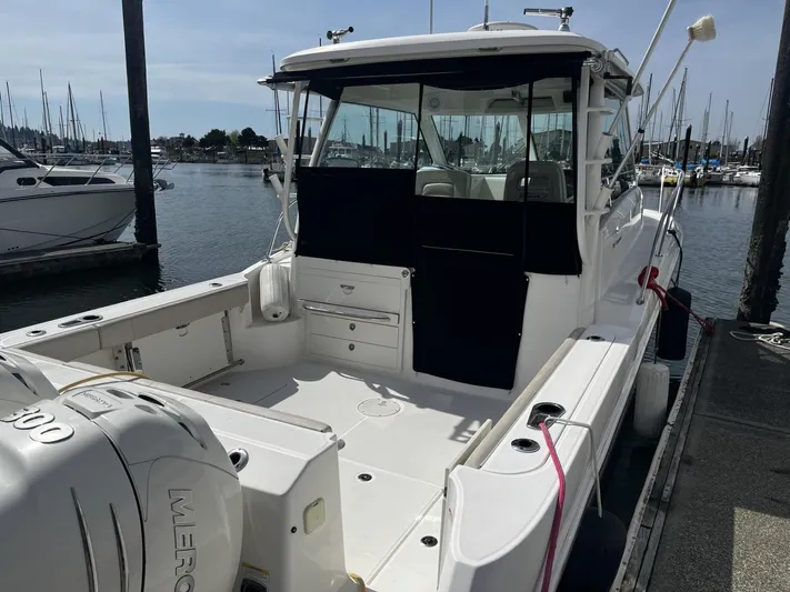  Yacht Photos Pics 2017 Boston Whaler 315 Conquest docked at marina, showcasing spacious deck and powerful engine.