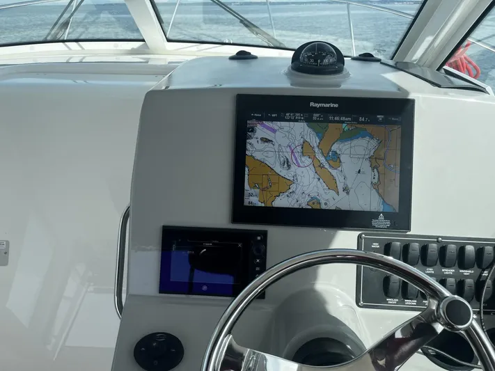  Yacht Photos Pics Helm of 2017 Boston Whaler 315 Conquest with navigation display and steering wheel.