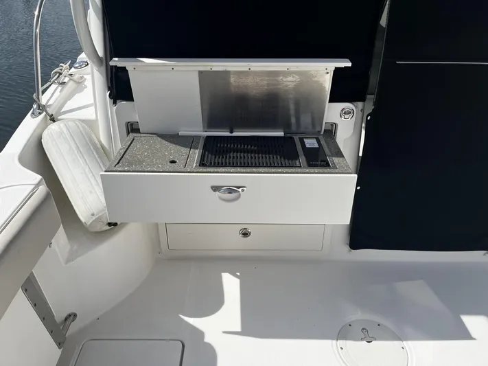  Yacht Photos Pics 2017 Boston Whaler 315 Conquest boat grill station with storage compartment.
