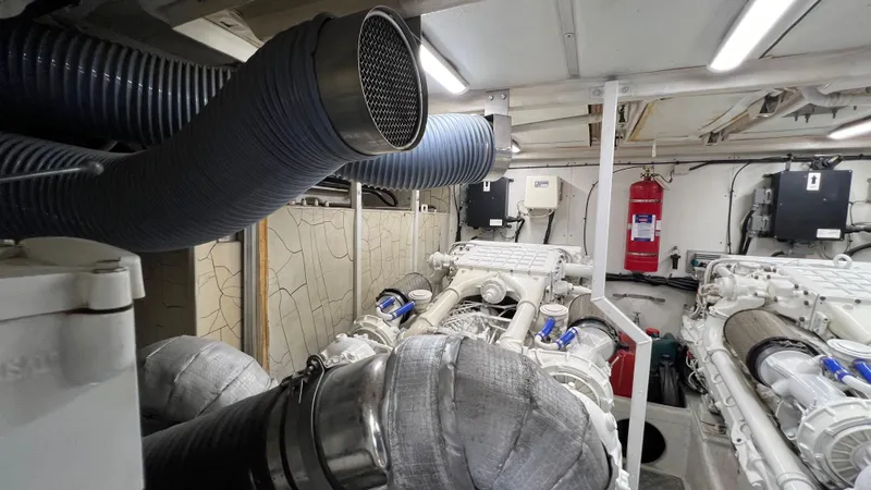 1691 Yacht Photos Pics Engine room of a 2000 Princess V65 yacht with visible exhaust pipes and machinery.