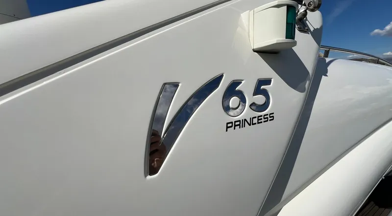 1691 Yacht Photos Pics Princess V65 yacht, 2000 model, close-up of logo and sleek design.