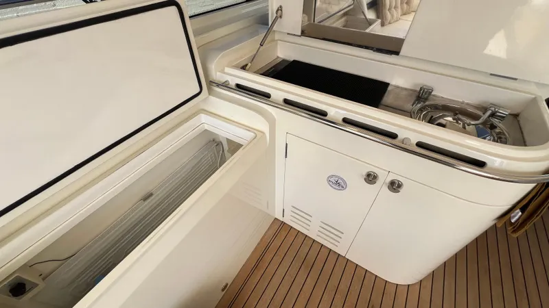 1691 Yacht Photos Pics Princess V65 yacht kitchen area with open storage and grill, featuring teak flooring, 2000 model.