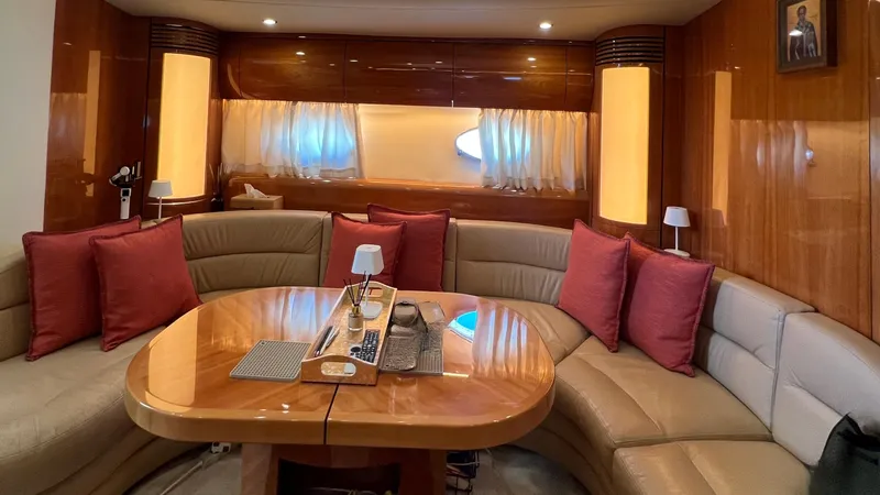 1691 Yacht Photos Pics Luxurious interior of 2000 Princess V65 yacht with elegant seating and wooden table.