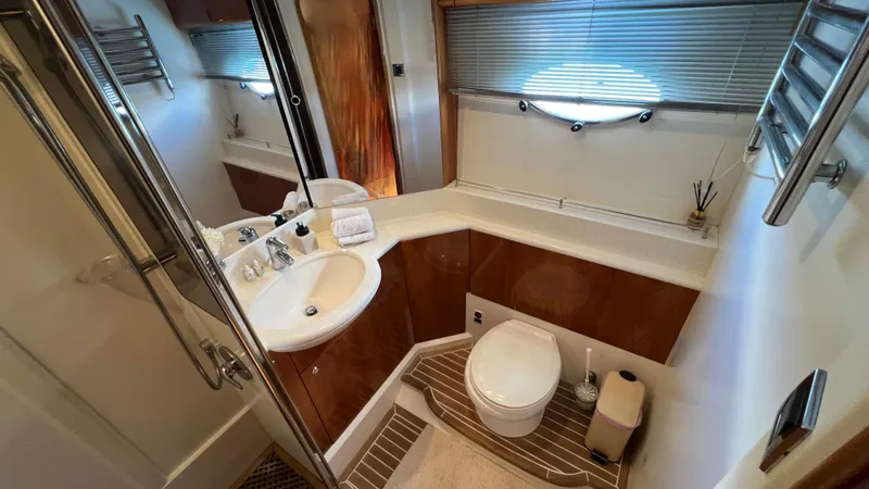 1691 Yacht Photos Pics Luxurious bathroom in 2000 Princess V65 yacht with modern fixtures and elegant design.