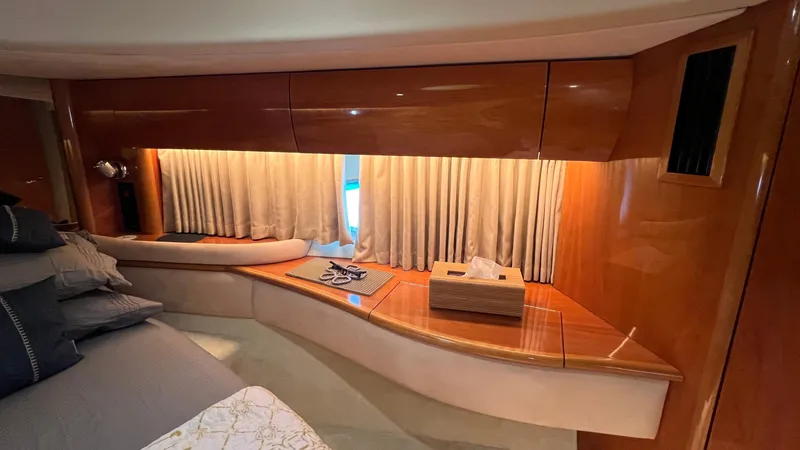 1691 Yacht Photos Pics Luxurious interior of 2000 Princess V65 yacht with elegant wood finish and cozy seating.