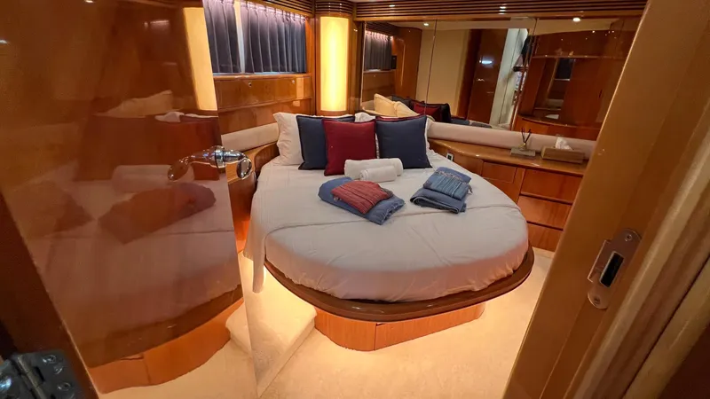 1691 Yacht Photos Pics Luxurious cabin interior of 2000 Princess V65 yacht with cozy bed and elegant decor.