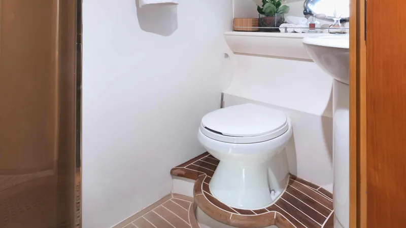 1691 Yacht Photos Pics Luxurious bathroom on 2000 Princess V65 yacht with modern fixtures and wooden flooring.