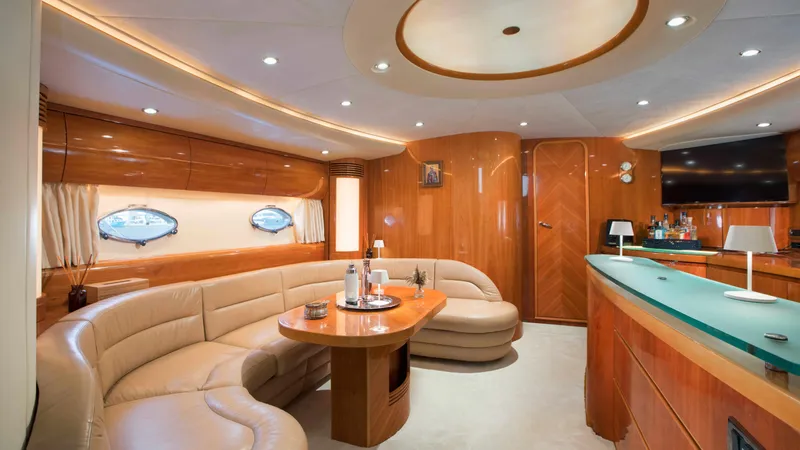 1691 Yacht Photos Pics Luxurious interior of a 2000 Princess V65 yacht with elegant wood finishes and plush seating.
