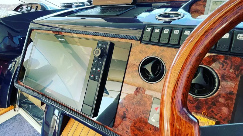 1691 Yacht Photos Pics Dashboard of a 2000 Princess V65 yacht with wood finish and navigation controls.