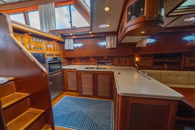 Dreadnought Yacht Photos Pics Luxurious 2007 Vicem 65 yacht interior with wooden cabinetry and modern kitchen amenities.