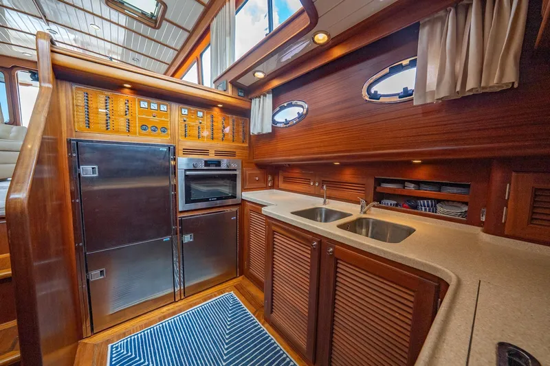 Dreadnought Yacht Photos Pics Luxurious 2007 Vicem 65 yacht kitchen with wood cabinetry and stainless steel appliances.