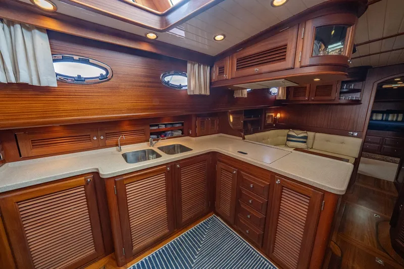 Dreadnought Yacht Photos Pics Luxurious 2007 Vicem 65 yacht interior with elegant wood cabinetry and modern kitchen amenities.